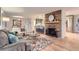 Stylish living room featuring a stone fireplace, open layout, and modern furnishings at 10698 W 26Th Ave, Lakewood, CO 80215
