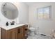 Bathroom with modern vanity, large mirror, and marble flooring at 3980 Home St, Castle Rock, CO 80108