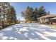 Brick ranch house with a snow-covered driveway and landscaping at 3980 Home St, Castle Rock, CO 80108