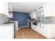 Modern kitchen with white shaker cabinets, stainless steel appliances, and granite countertops at 3980 Home St, Castle Rock, CO 80108