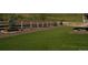 Sprawling backyard with synthetic lawn, white fencing, rock beds, and manicured landscaping at 4121 River Oaks St, Castle Rock, CO 80104