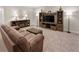 Inviting finished basement featuring a comfortable living area and entertainment center with fireplace at 4121 River Oaks St, Castle Rock, CO 80104