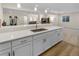 Basement bar area featuring white cabinets, a sink, and quartz countertops at 4121 River Oaks St, Castle Rock, CO 80104