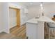 Basement wet bar with white cabinets, a stainless steel sink, and a stylish countertop at 4121 River Oaks St, Castle Rock, CO 80104