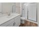 Modern bathroom featuring a white vanity, a shower with glass doors, and neutral wall paint at 4121 River Oaks St, Castle Rock, CO 80104