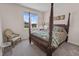 Bedroom featuring carpet flooring, four poster bed, and a chair next to a window at 4121 River Oaks St, Castle Rock, CO 80104