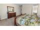 Bedroom featuring carpet flooring, wood dresser, and decorative mirror at 4121 River Oaks St, Castle Rock, CO 80104