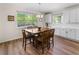 Cozy dining area features a wooden table, natural lighting, and convenient access to the kitchen at 4121 River Oaks St, Castle Rock, CO 80104