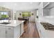 Well-lit kitchen flows into the dining area featuring white cabinets, modern appliances, and an eat-in dining area at 4121 River Oaks St, Castle Rock, CO 80104