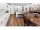 Open-concept kitchen and dining area with an island, counter seating, and modern stainless steel appliances at 4121 River Oaks St, Castle Rock, CO 80104