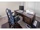 Comfortable home office area featuring a dark wood desk, office chair, and neutral carpet at 4121 River Oaks St, Castle Rock, CO 80104