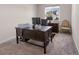 Bright home office featuring a dark wood desk, beige carpet, and a window view of neighboring houses at 4121 River Oaks St, Castle Rock, CO 80104