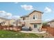 Exterior view of home showcasing a large backyard with a deck and a hot tub at 12753 Buckhorn Creek St, Parker, CO 80134