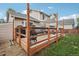 This backyard features a spacious wooden deck with a sun shade, seating area and plenty of space for entertaining at 12753 Buckhorn Creek St, Parker, CO 80134