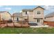 This home features an expansive back deck, perfect for entertaining with a hot tub and comfortable seating area at 12753 Buckhorn Creek St, Parker, CO 80134