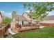 Enjoy this backyard with large wooden deck with seating and a hot tub surrounded by lush green grass at 12753 Buckhorn Creek St, Parker, CO 80134