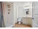Bathroom features a neutral vanity, toilet, and shower with bright, colorful shower curtain at 12753 Buckhorn Creek St, Parker, CO 80134