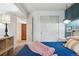 This bedroom boasts modern lighting fixture, light walls, and closet with slider doors at 12753 Buckhorn Creek St, Parker, CO 80134