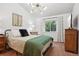 Bright bedroom featuring a modern light fixture, a window, and neutral decor at 12753 Buckhorn Creek St, Parker, CO 80134