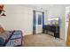 Cozy carpeted bedroom with a TV, storage dresser, window, and bright walls at 12753 Buckhorn Creek St, Parker, CO 80134