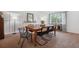 Elegant dining room boasting a rustic wooden table, stylish chairs, and abundant natural light at 12753 Buckhorn Creek St, Parker, CO 80134