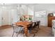 Open dining room with a wooden table, modern lighting, and access to the staircase at 12753 Buckhorn Creek St, Parker, CO 80134