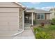 Front of house with stone accents, landscaped yard, and covered front porch at 12753 Buckhorn Creek St, Parker, CO 80134