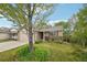 Landscaped front yard featuring mature tree, green grass, and single story home at 12753 Buckhorn Creek St, Parker, CO 80134