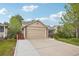 Tan home with a two car garage, stone accents and a well manicured front yard at 12753 Buckhorn Creek St, Parker, CO 80134
