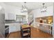 Modern kitchen with stainless steel appliances, light gray cabinets, and hardwood floors at 12753 Buckhorn Creek St, Parker, CO 80134