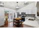 Modern kitchen with stainless steel appliances, gray subway tile backsplash, and wood floors at 12753 Buckhorn Creek St, Parker, CO 80134