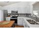 Bright kitchen featuring stainless appliances, gray backsplash, and wood flooring at 12753 Buckhorn Creek St, Parker, CO 80134