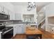 Well-lit kitchen with white countertops, gray backsplash, and stainless steel appliances at 12753 Buckhorn Creek St, Parker, CO 80134