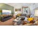 Cozy living room with a plush gray sofa, colorful cushions, and bright window at 12753 Buckhorn Creek St, Parker, CO 80134