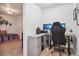 Open office next to bedroom with a desk, dual monitors, storage, and overhead lighting at 12753 Buckhorn Creek St, Parker, CO 80134