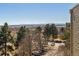 Scenic aerial view of community with lush greenery, distant mountains, and convenient parking at 13631 E Marina Dr # 608, Aurora, CO 80014