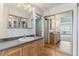 Bathroom with wood cabinets, laminate countertops, and a mirrored closet at 13631 E Marina Dr # 608, Aurora, CO 80014