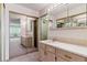 Bathroom features a sink, wood cabinets, mirrored closet and connected toilet room at 13631 E Marina Dr # 608, Aurora, CO 80014