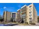 Attractive condo building exterior with large windows and neatly trimmed greenery at 13631 E Marina Dr # 608, Aurora, CO 80014
