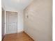 Hallway features a door, wood floors, and neutral colored walls at 13631 E Marina Dr # 608, Aurora, CO 80014