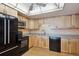 Efficient kitchen featuring sleek black appliances, light wood cabinets, and modern hardware at 13631 E Marina Dr # 608, Aurora, CO 80014