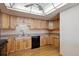 A cozy kitchen area with updated fixtures, light wood cabinets, and functional design at 13631 E Marina Dr # 608, Aurora, CO 80014