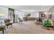 Inviting living room with neutral carpet, comfortable seating, and ample natural light through large windows at 13631 E Marina Dr # 608, Aurora, CO 80014