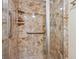 Close-up of shower featuring marbled walls and a built-in shelf at 13631 E Marina Dr # 608, Aurora, CO 80014