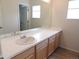 Bathroom featuring a large mirror and a sink with wooden cabinets underneath, providing ample storage space at 5223 Gray Wolf Ln, Castle Rock, CO 80104