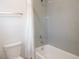 Clean white bathroom with a shower-tub combination and tiled walls at 5223 Gray Wolf Ln, Castle Rock, CO 80104