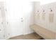 Bright entryway featuring shiplap accents, bench seating, and hooks for storage at 5223 Gray Wolf Ln, Castle Rock, CO 80104