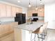 Bright kitchen featuring granite counters, stainless steel appliances, and a large island with seating at 5223 Gray Wolf Ln, Castle Rock, CO 80104