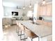 Kitchen island with seating open to the living room, modern lighting, and hardwood floors at 5223 Gray Wolf Ln, Castle Rock, CO 80104