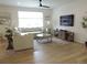 Bright, open living room with hardwood floors, modern lighting, and stylish furniture arrangement at 5223 Gray Wolf Ln, Castle Rock, CO 80104